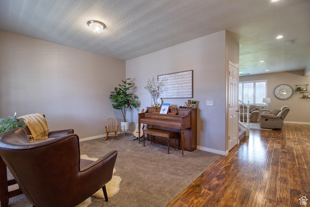 living area with hardwood / wood-style floors and a textured ceiling