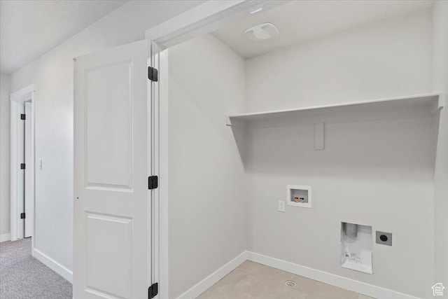 washroom with hookup for an electric dryer, hookup for a washing machine, and baseboards