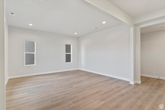 unfurnished room featuring light wood finished floors, recessed lighting, and baseboards