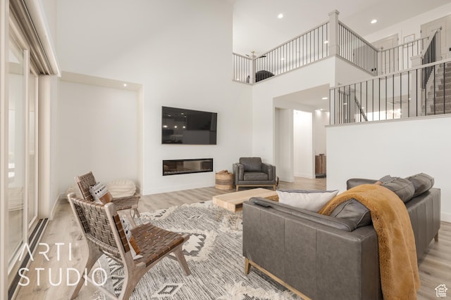 3235 S Retreat Dr, Hurricane, UT 84737 - living room featuring light wood-type flooring and a towering ceiling