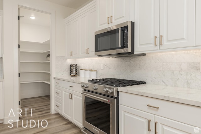 3235 S Retreat Dr, Hurricane, UT 84737 - kitchen featuring white cabinets, stainless steel appliances, light stone counters, and tasteful backsplash