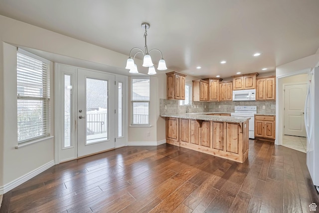 893 N 400 E, Springville, UT 84663 - kitchen with white appliances, a peninsula, dark wood finished floors, tasteful backsplash, and recessed lighting
