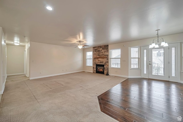 893 N 400 E, Springville, UT 84663 - unfurnished living room featuring a stone fireplace, a chandelier, a ceiling fan, light wood-style floors, and recessed lighting