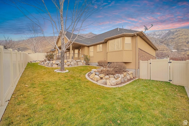 893 N 400 E, Springville, UT 84663 - yard at dusk with a gate, a fenced backyard, and a mountain view