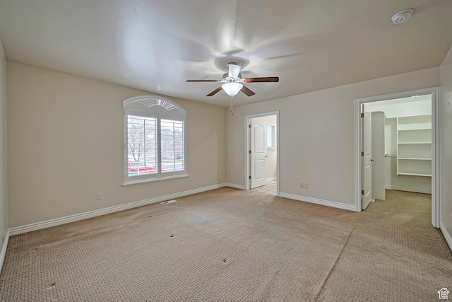 893 N 400 E, Springville, UT 84663 - unfurnished bedroom featuring light carpet, a walk in closet, connected bathroom, and a ceiling fan
