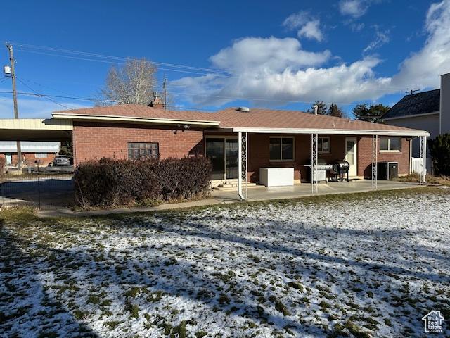 2429 W 300 N, West Point, UT 84015 - snow covered property featuring a carport