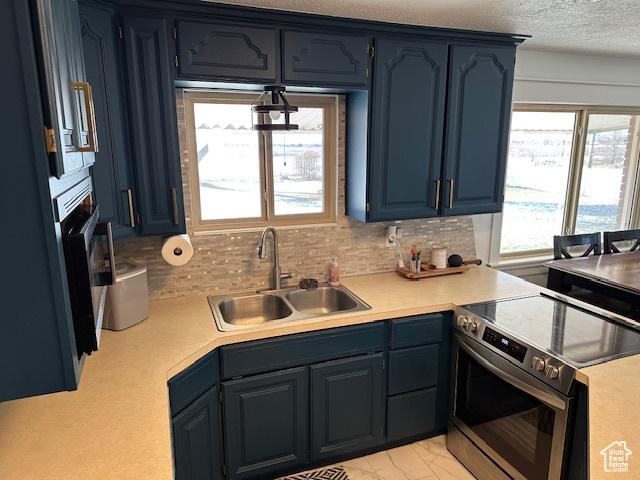 2429 W 300 N, West Point, UT 84015 - kitchen featuring stainless steel electric stove, blue cabinetry, sink, and tasteful backsplash