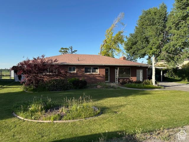 2429 W 300 N, West Point, UT 84015 - ranch-style house featuring a front lawn, concrete driveway, and a chimney