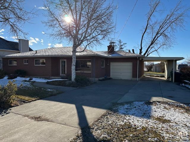 single story home with a garage and a carport