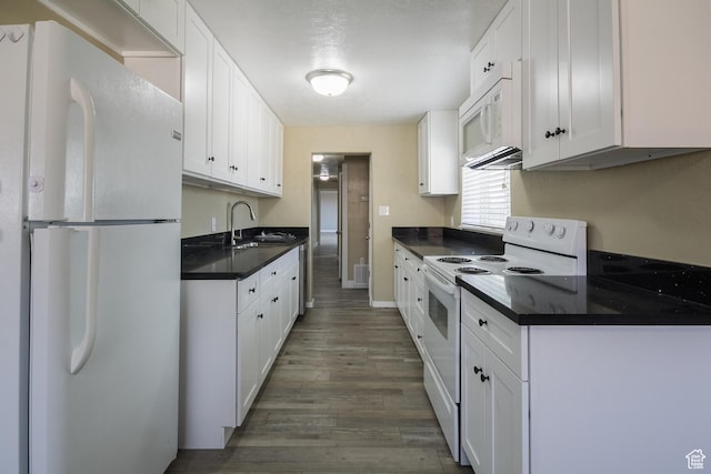 kitchen featuring white cabinetry, dark hardwood / wood-style flooring, white appliances, and sink