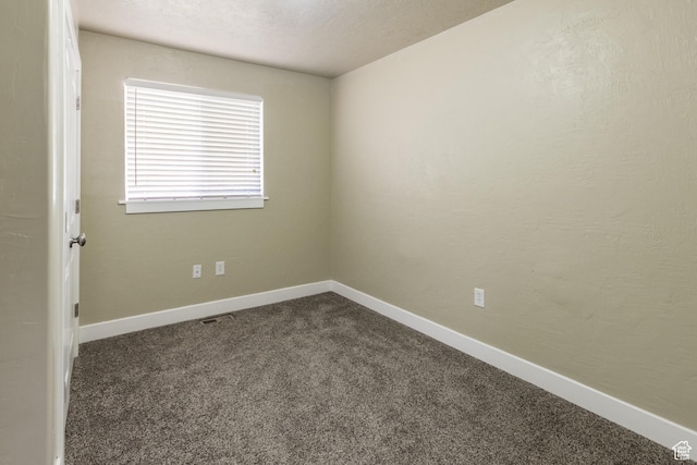 unfurnished room featuring carpet