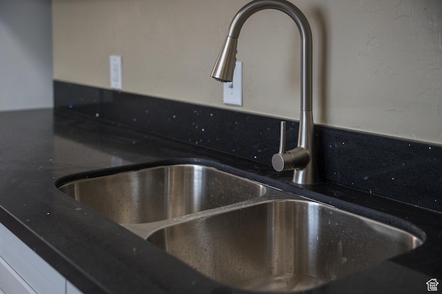room details with white cabinetry and sink