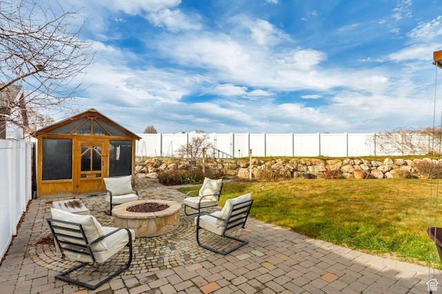 563 W Kalia Cv, Murray, UT 84123 - view of patio with an outbuilding and an outdoor fire pit