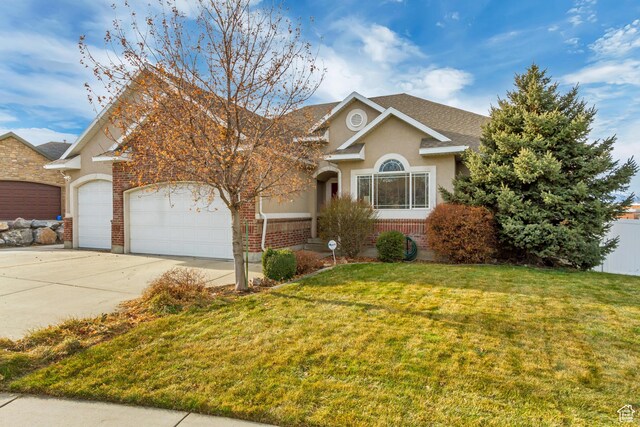 563 W Kalia Cv, Murray, UT 84123 - view of front of home featuring a garage and a front yard