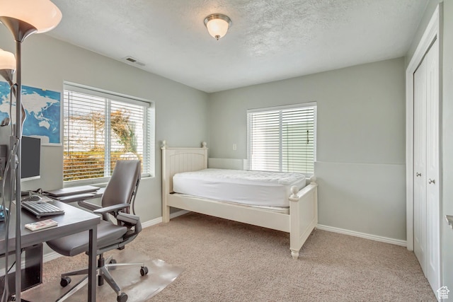 563 W Kalia Cv, Murray, UT 84123 - bedroom with a textured ceiling, light carpet, and a closet