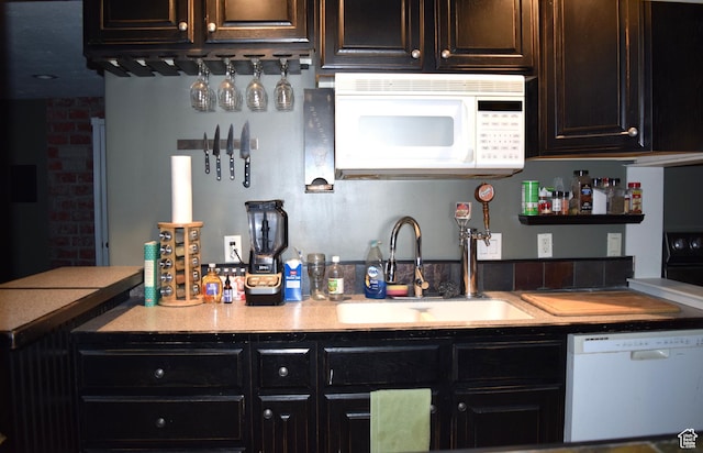 563 W Kalia Cv, Murray, UT 84123 - kitchen with dark brown cabinets, sink, and white appliances
