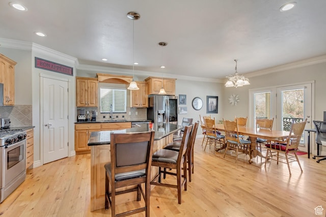 563 W Kalia Cv, Murray, UT 84123 - kitchen with pendant lighting, a center island, sink, ornamental molding, and appliances with stainless steel finishes