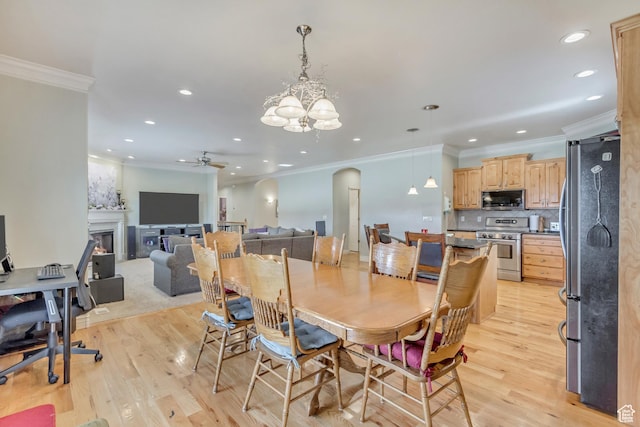 563 W Kalia Cv, Murray, UT 84123 - dining space with ceiling fan with notable chandelier, light hardwood / wood-style flooring, and crown molding