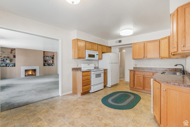 1194 E 2700 S Unit C18, Salt Lake City, UT 84106 - kitchen with built in shelves, light colored carpet, white appliances, and sink