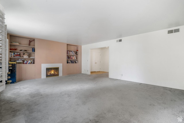 1194 E 2700 S Unit C18, Salt Lake City, UT 84106 - unfurnished living room featuring built in features and carpet