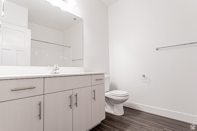 13714 S Hanley Ln Unit Hh204, Riverton, UT 84096 - bathroom featuring vanity, toilet, wood finished floors, baseboards, and a shower