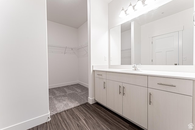 13714 S Hanley Ln Unit Hh204, Riverton, UT 84096 - bathroom featuring vanity, wood finished floors, a spacious closet, and baseboards