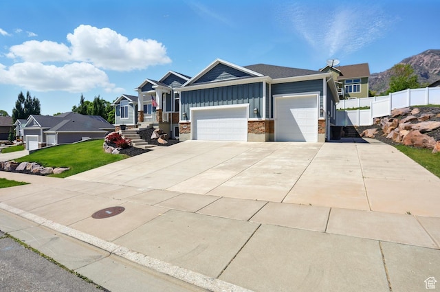 690 W 4125 N, Pleasant View, UT 84414 - view of front facade featuring board and batten siding, an attached garage, and concrete driveway