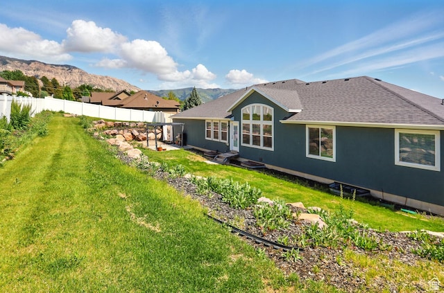 690 W 4125 N, Pleasant View, UT 84414 - rear view of property with a mountain view, roof with shingles, a patio area, and stucco siding