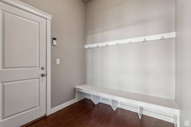 mudroom featuring baseboards and dark wood finished floors
