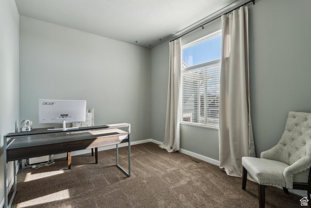carpeted office space with visible vents and baseboards