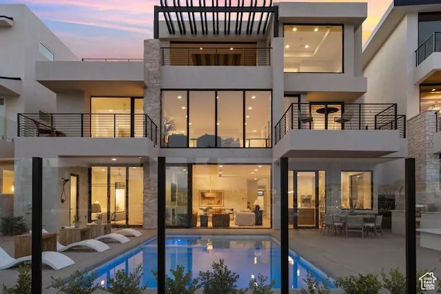 5359 S Pura Cir Unit 142, St George, UT 84790 - back house at dusk featuring a patio area