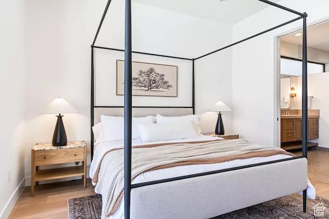 5359 S Pura Cir Unit 142, St George, UT 84790 - bedroom with wood-type flooring, ensuite bath, and sink