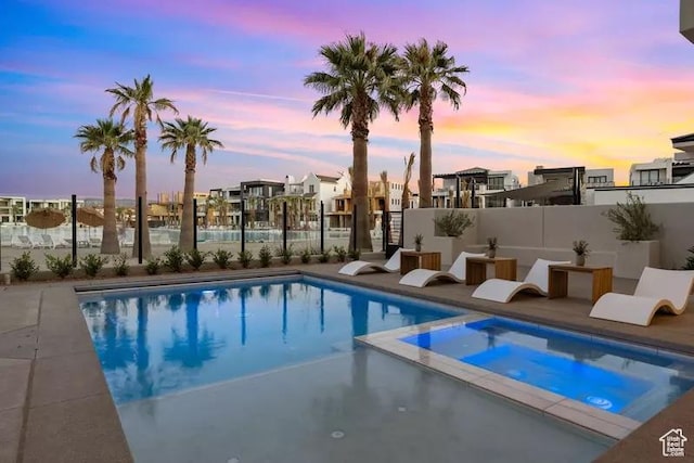 5359 S Pura Cir Unit 142, St George, UT 84790 - pool at dusk featuring an in ground hot tub
