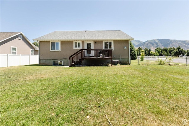 287 S 375 W, Providence, UT 84332 - back of property with a lawn and a deck with mountain view
