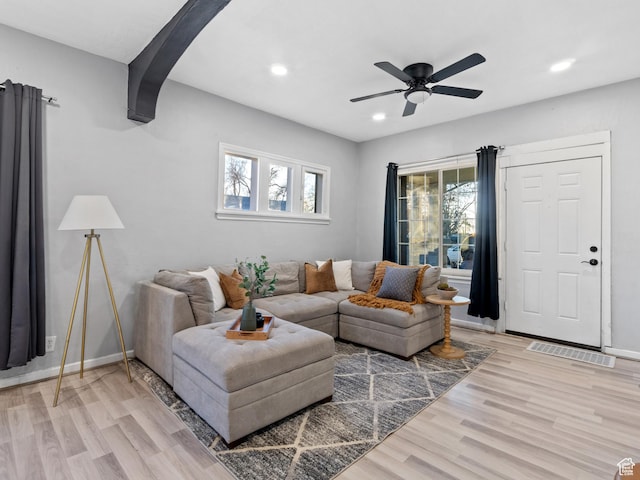 living room with ceiling fan and light wood-type flooring