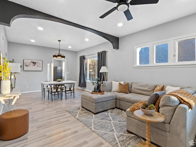 living room featuring ceiling fan and light hardwood / wood-style floors