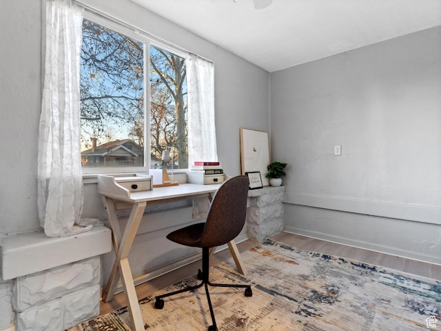 home office with wood-type flooring
