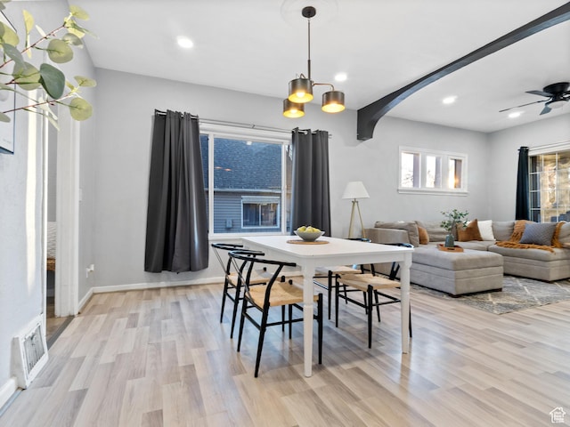 dining room featuring ceiling fan with notable chandelier and light wood-type flooring