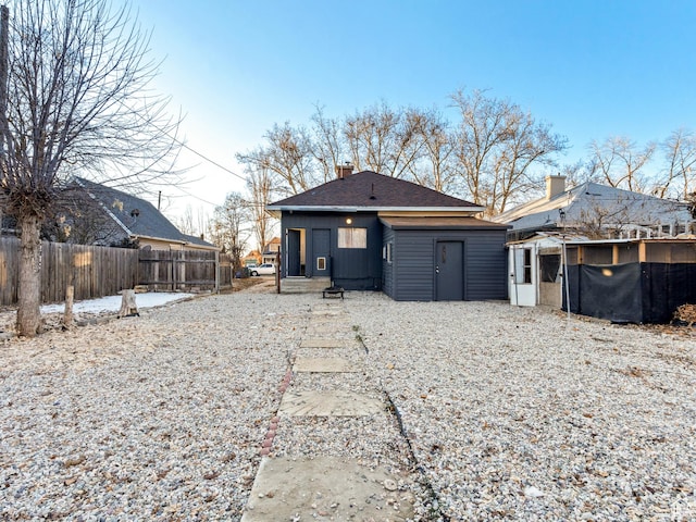 back of property featuring a swimming pool