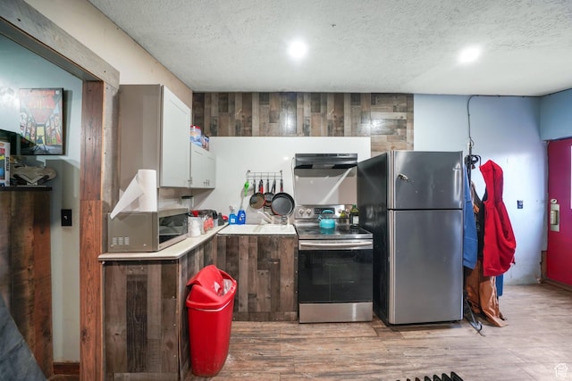 513 W Lake St, Ogden, UT 84401 - kitchen with white cabinetry, ventilation hood, a textured ceiling, appliances with stainless steel finishes, and light wood-type flooring