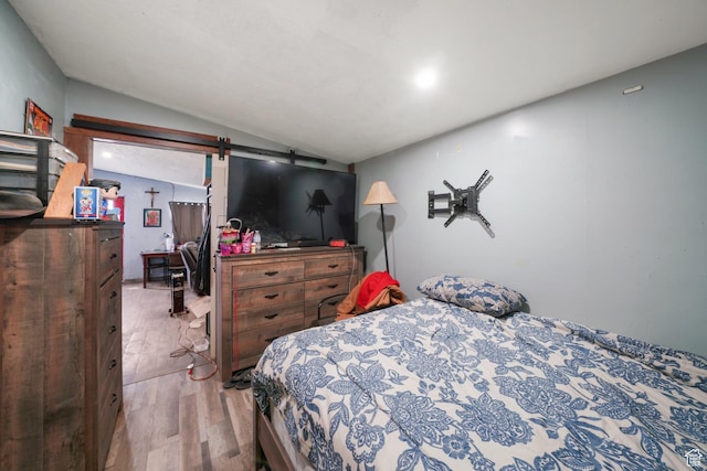 513 W Lake St, Ogden, UT 84401 - bedroom featuring light hardwood / wood-style floors, a barn door, and lofted ceiling