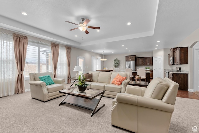 649 E 5650 S, Washington Terrace, UT 84405 - living room with ceiling fan with notable chandelier, a raised ceiling, and light carpet