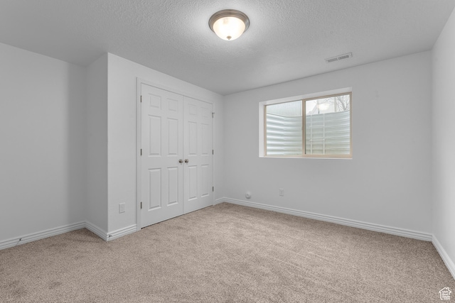 649 E 5650 S, Washington Terrace, UT 84405 - unfurnished bedroom with carpet, a textured ceiling, and a closet