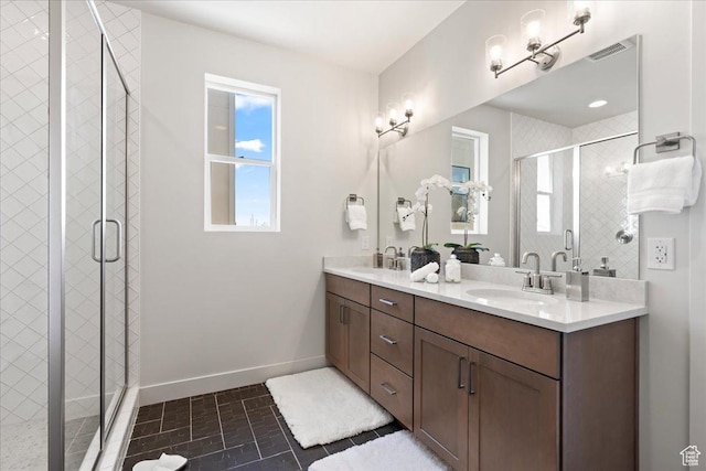 bathroom with tile patterned flooring, vanity, and a shower with shower door