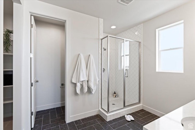 bathroom with vanity and a shower with shower door