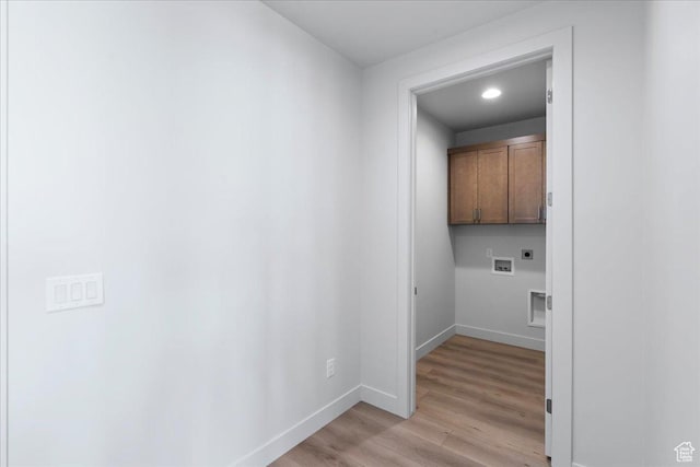 washroom with electric dryer hookup, hookup for a washing machine, cabinets, and light wood-type flooring