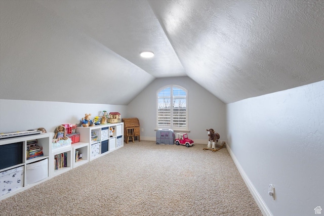 game room featuring carpet flooring, a textured ceiling, and vaulted ceiling