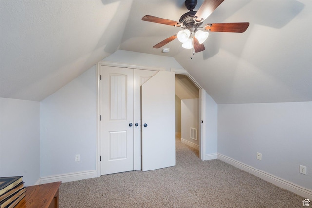 bonus room featuring light colored carpet, ceiling fan, and lofted ceiling