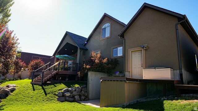 back of property with a lawn