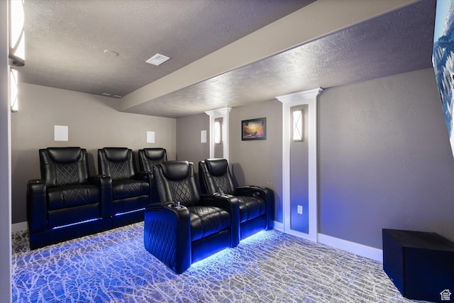 cinema with ornate columns and a textured ceiling
